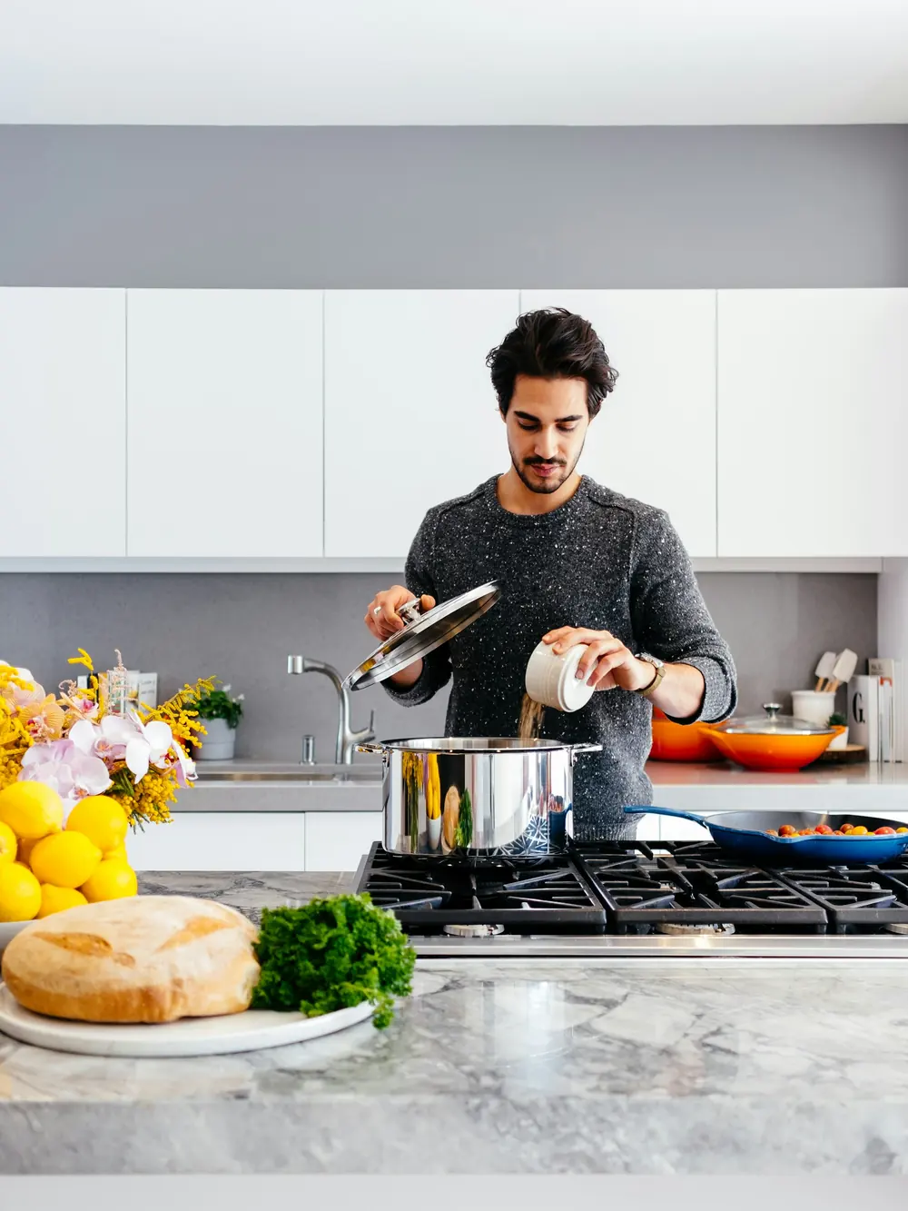 A man cooking in a bright home kitchen