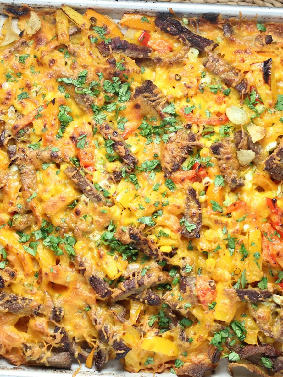 A full sheet pan of baked vegetables and cheese fresh from the oven