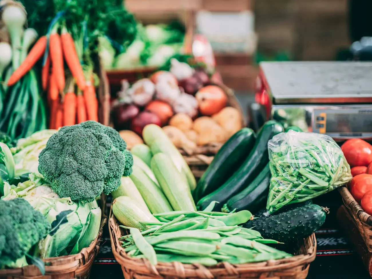 Broccoli, carrots, green beans and tomatoes at a market stall